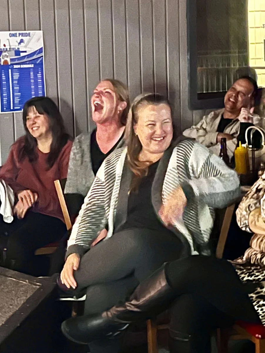 Comedy Series audience members laughing during a show