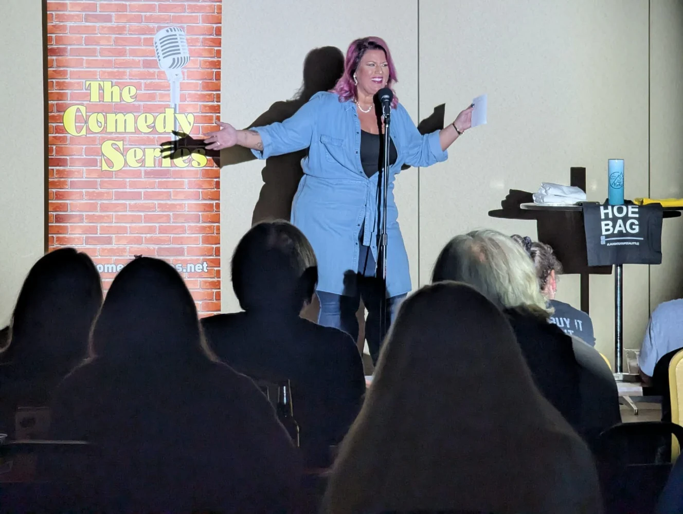 Melissa Hager performing beside The Comedy Series banner